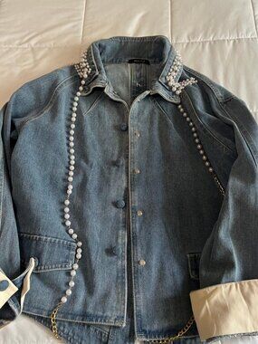 Denim jacket with pearls.